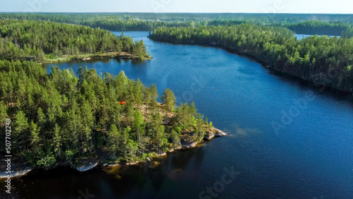 Flight over lakes and forests in Karelia near the village of Kuznechnoye in Russia.
