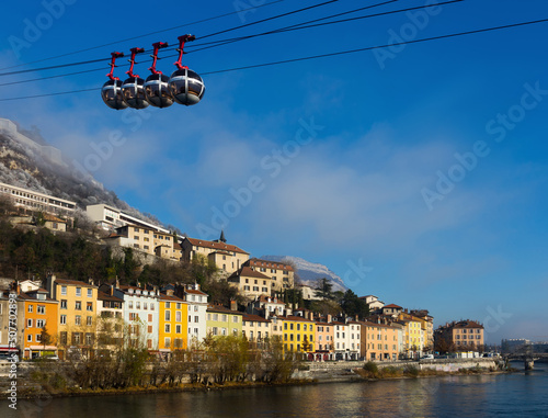 Grenoble cable car and right bank of Isere river in winter day