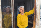 senior Caucasian woman thoughtfully looking out the window medium shot indoor senior people and quarantine concept. High quality photo