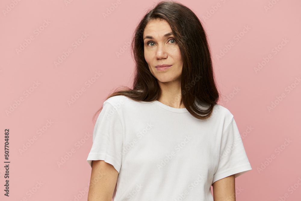 horizontal portrait of a cute attractive woman on a pink background in a clean white tank top smiling pleasantly at the camera horizontal portrait of a cute attractive woman on a pink background in a clean white tank top smiling pleasantly at the camera