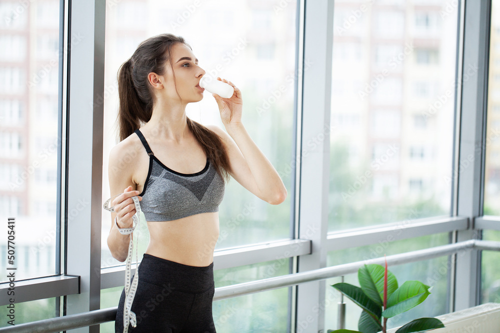 Young beautiful woman drinking from plastic bottle of yogurt Young beautiful woman drinking from plastic bottle of yogurt