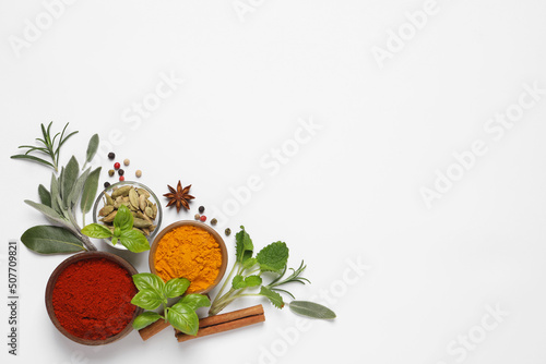 Different herbs and spices on white background, top view