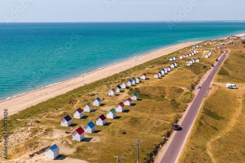 Colourful beach huts, wooden beach cabins in Gouville-sur-Mer, Normandy, France.