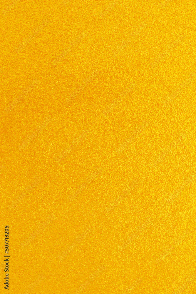 Fototapeta premium Gold or yellow paint on cement wall texture background.