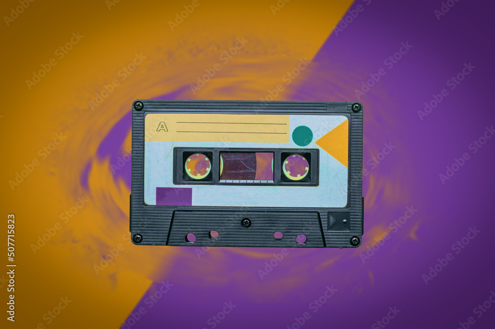 Fototapeta premium Retro tape recorder on a yellow-purple background.