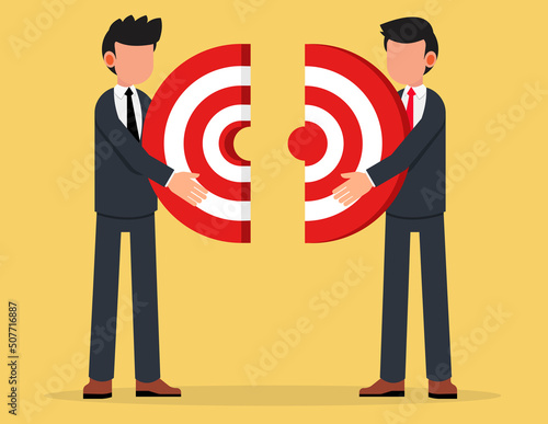 Two businessmen connecting puzzle elements. Business metaphor of a joint venture, partnership or teamwork