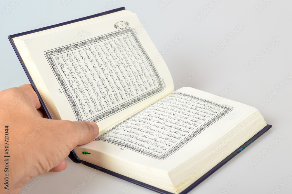 Obraz premium Holy Al Quran with written in arabic calligraphy isolated on a white background