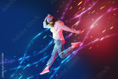 Beautiful jumping female hip-hop dancer against colorful background © Pixel-Shot