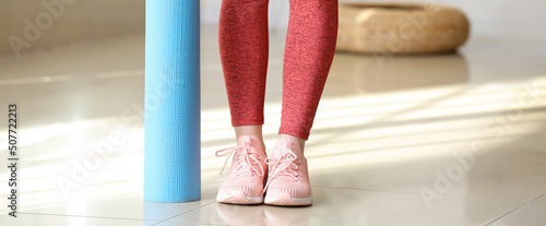 Sporty young woman with yog...