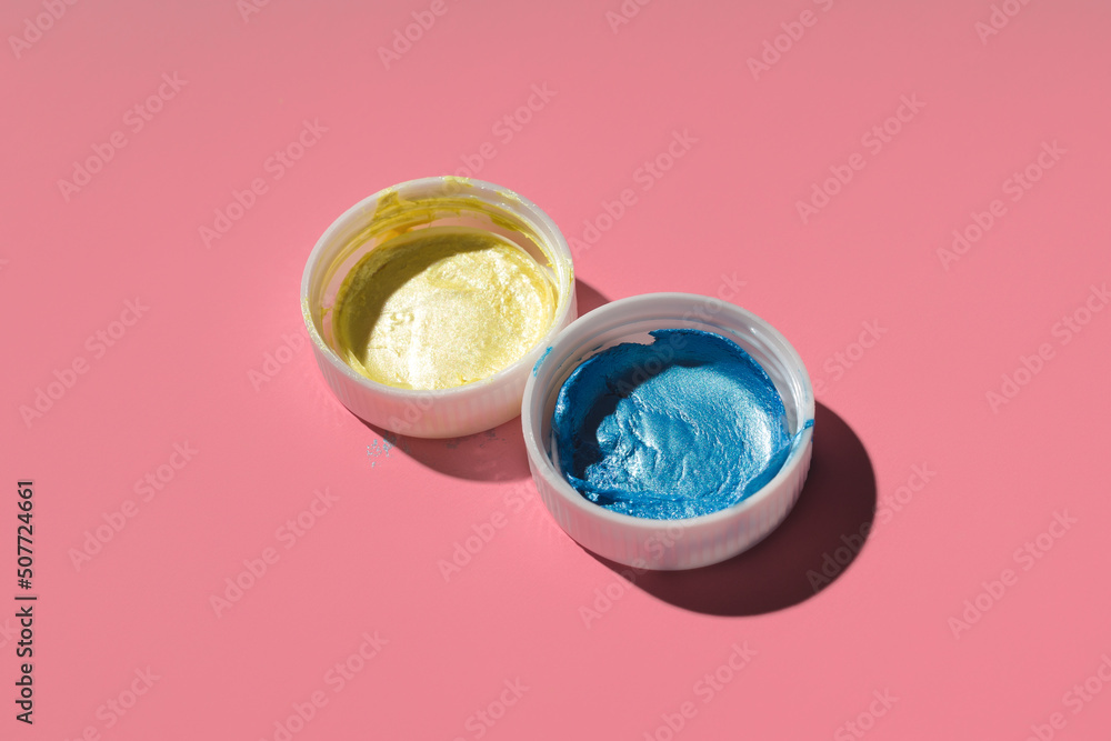 yellow and blue acrylic paint on a colored background yellow and blue acrylic paint on a colored background