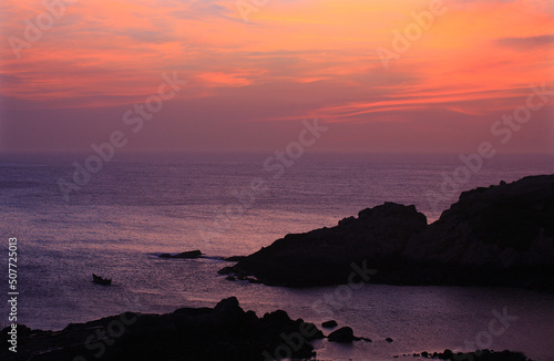 Red sunrise or sunset at the seaside fills the sky photo