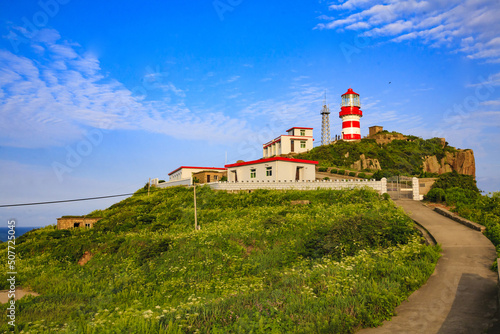 The lighthouse on the sea under blue sky photo