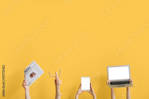 People with newspaper, gadg...