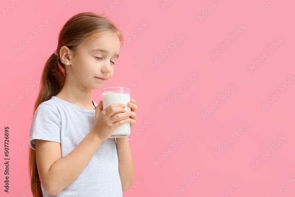 Little girl holding big glass of milk on color background Little girl holding big glass of milk on color background