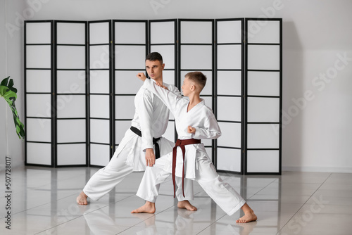 Boy practicing karate with ...