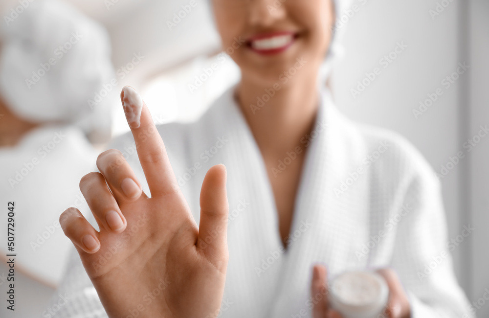 Young woman with coconut oil in bathroom, closeup Young woman with coconut oil in bathroom, closeup