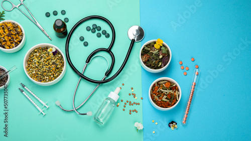 Assortment of herbal and traditional medicine on colourful background.