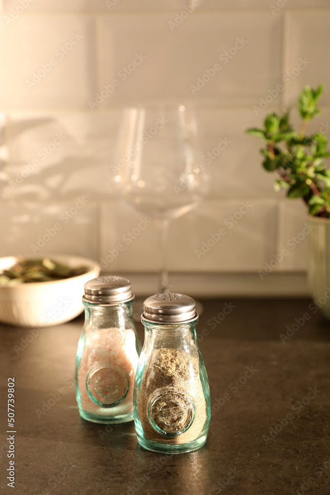 Salt and pepper shaker on kitchen table Salt and pepper shaker on kitchen table