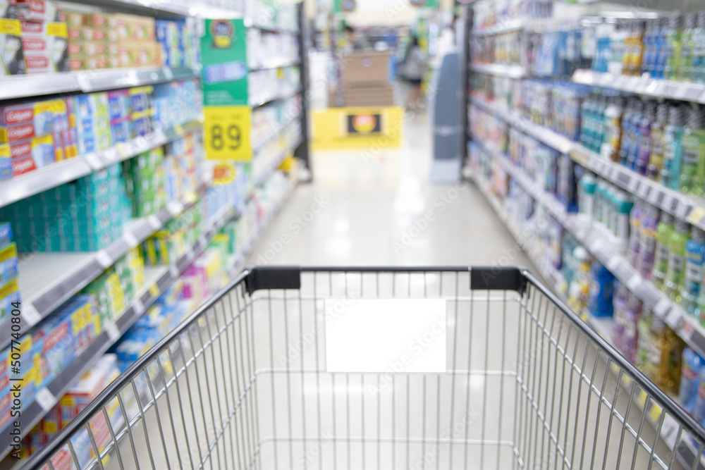 Shopping cart in supermarket, Abstract blurred photo in shopping malls, Cart in the market, wide variety of products are placed on the shelves for an orderly display. Shopping cart in supermarket, Abstract blurred photo in shopping malls, Cart in the market, wide variety of products are placed on the shelves for an orderly display.