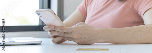 Close-up image of woman's hand holding a phone or smartphone For internet and entertainment or to relax after working in the office, Technology communication and internet networking.