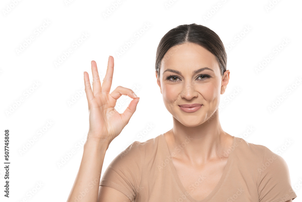 Young smiling woman with delicious gesture on white studio background Young smiling woman with delicious gesture on white studio background