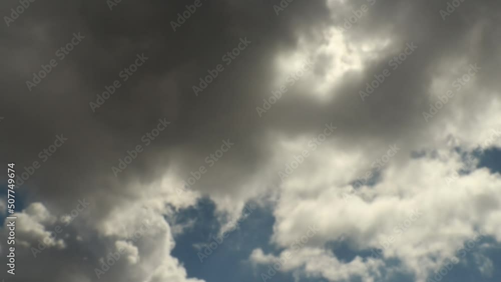 Fast moving soft clouds with a backlight over a grey blue sky Fast moving soft clouds with a backlight over a grey blue sky