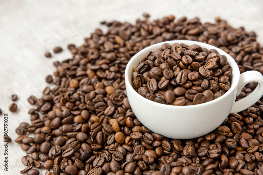Coffee beans in a white cup Coffee beans in a white cup
