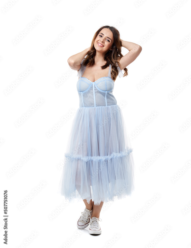 Naklejka premium Happy young woman in blue dress on white