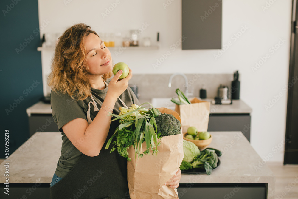 Still life with green fruit and vegetables on grey table in the kitchen interior. Still life with green fruit and vegetables on grey table in the kitchen interior.