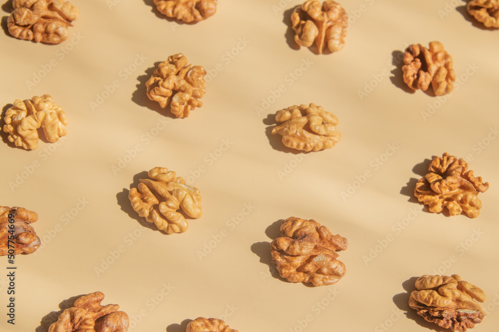 Pattern with peeled halves of walnuts top view. Food abstract background with nuts Pattern with peeled halves of walnuts top view. Food abstract background with nuts