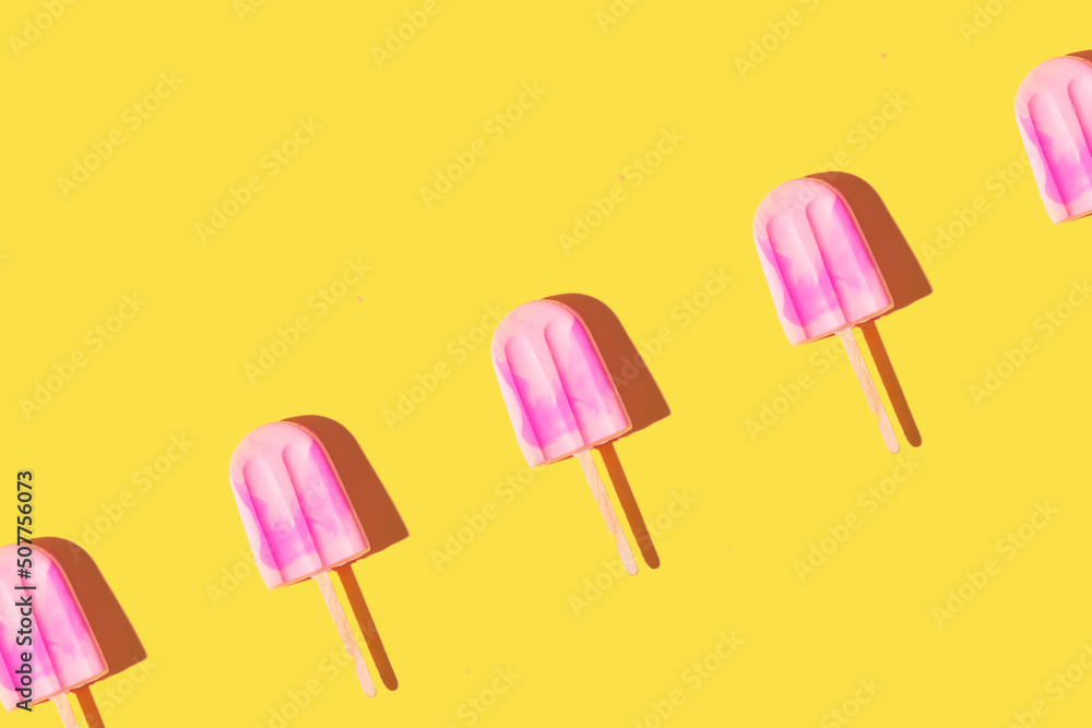 Trendy sunlight Summer pattern made with pink ice cream on bright light yellow background. Minimal summer concept Trendy sunlight Summer pattern made with pink ice cream on bright light yellow background. Minimal summer concept