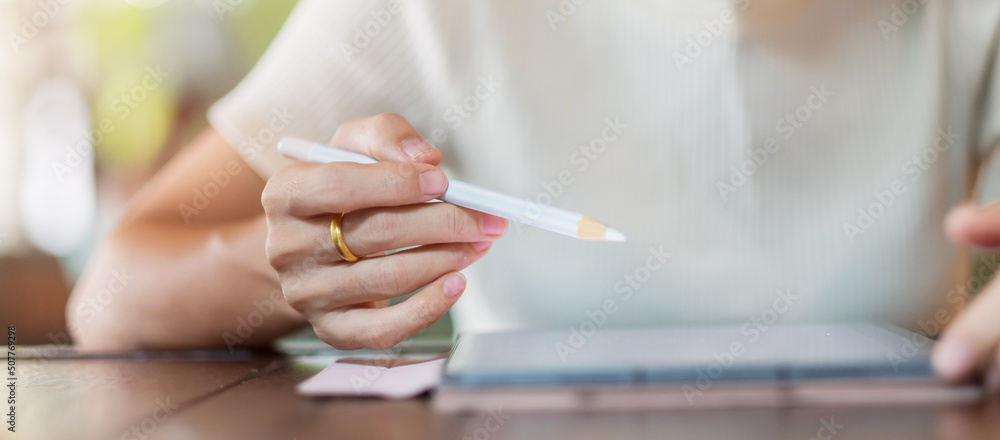 woman using tablet for sms messages, hand holding pencil typing touchscreen mobile phone in cafe or modern office. lifestyle, technology, Social media and network concept woman using tablet for sms messages, hand holding pencil typing touchscreen mobile phone in cafe or modern office. lifestyle, technology, Social media and network concept