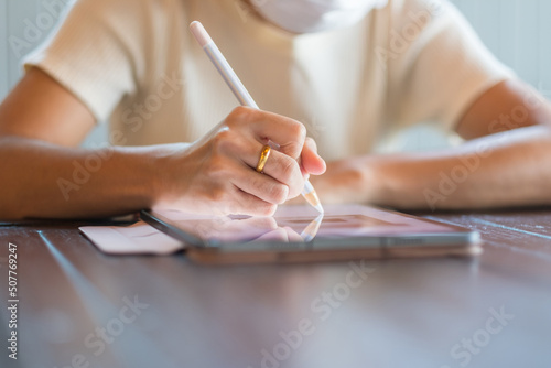 woman using tablet for sms messages, hand holding pencil typing touchscreen mobile phone in cafe or modern office. lifestyle, technology, Social media and network concept