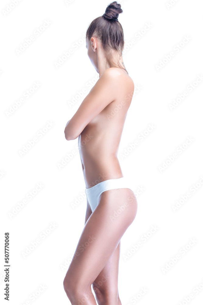 One Sexy Nude and Naked Winsome Caucasian Female With Tanned Curved Slim Body Standing With Crossed Hands While Posing Over Pure White. One Sexy Nude and Naked Winsome Caucasian Female With Tanned Curved Slim Body Standing With Crossed Hands While Posing Over Pure White.