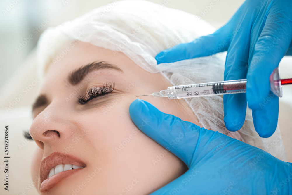 Closeup of Cosmetologist Hand While Injections Process for Lips, Eyelashes and Skin Augmentation For Anti Wrinkle For Young Female Caucasian Woman in Beauty salon Closeup of Cosmetologist Hand While Injections Process for Lips, Eyelashes and Skin Augmentation For Anti Wrinkle For Young Female Caucasian Woman in Beauty salon