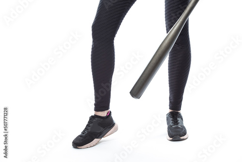Legs Of Female Baseball Player Athlete Posing With Bat On Pure White Background