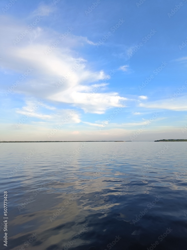 Lake shore under blue sky