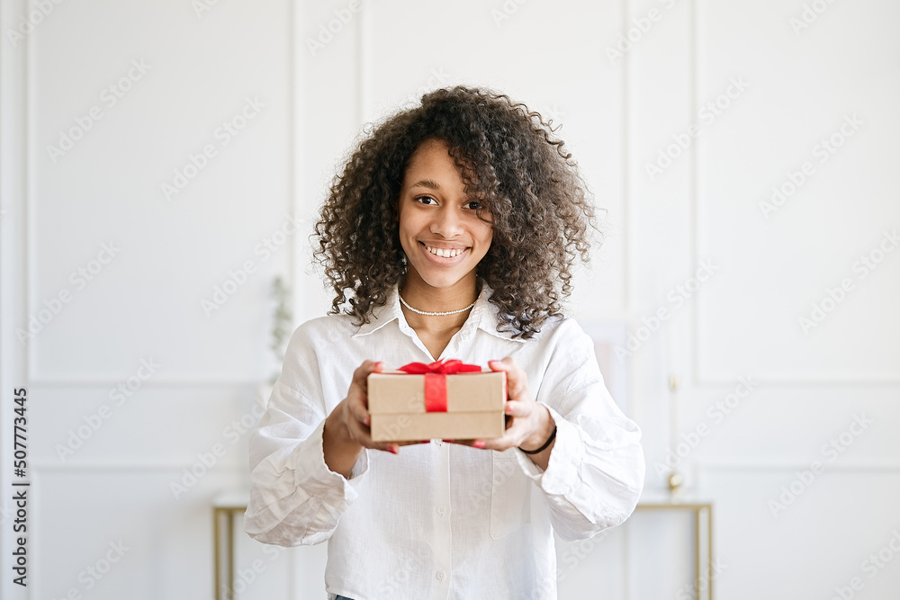 Excited african american young woman present gift box with ribbon. Family lifestyle, valentine's day, birthday holiday concept Excited african american young woman present gift box with ribbon. Family lifestyle, valentine's day, birthday holiday concept