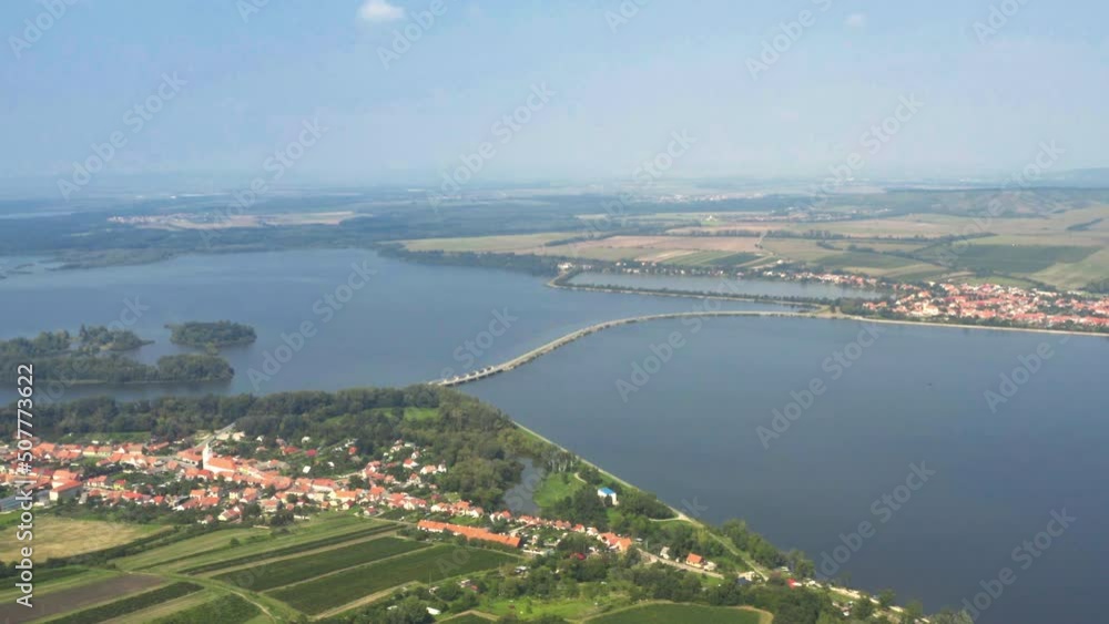 Narrow causeway over Věstonice reservoir between two villages, drone. Narrow causeway over Věstonice reservoir between two villages, drone.