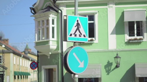 Pedestrian cross sign with beautiful green old building in the background. Location - Swedan - Hedemora city center. photo