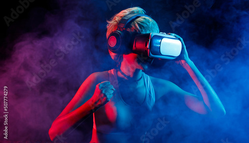 Blonde Hair Woman plays VR games with Goggles, have fun. Virtual reality is future gaming connect