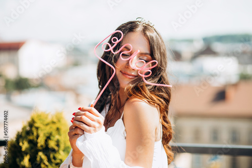 Happy bride celebrates bachelorette party, dancing and having fun on the roof of the house.