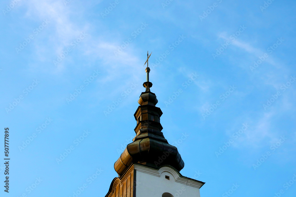 The old dome of the church against the blue sky.