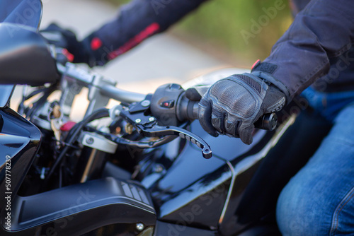 Motorcyclist holding the handlebars of a motorcycle © borisenkoket