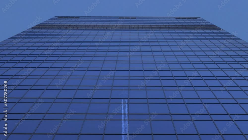 Reflection of Plane Flies Over Skyscraper on Blue Clear Sky Leaving White Traces Reflection of Plane Flies Over Skyscraper on Blue Clear Sky Leaving White Traces