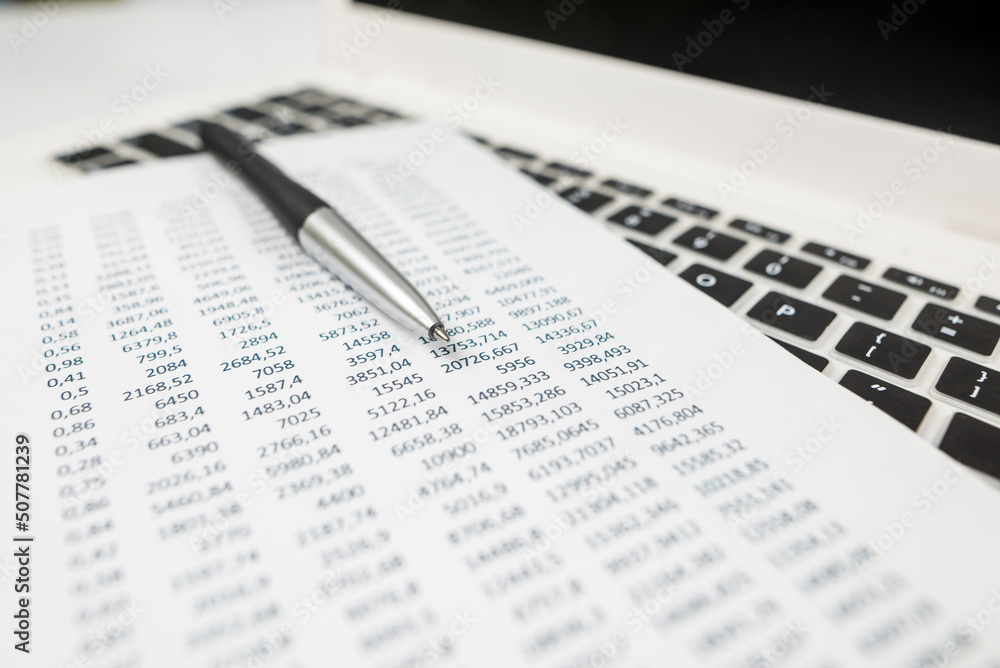 Obraz premium Sheet of paper with different financial figures. The concept of analysis, statistics, costing.