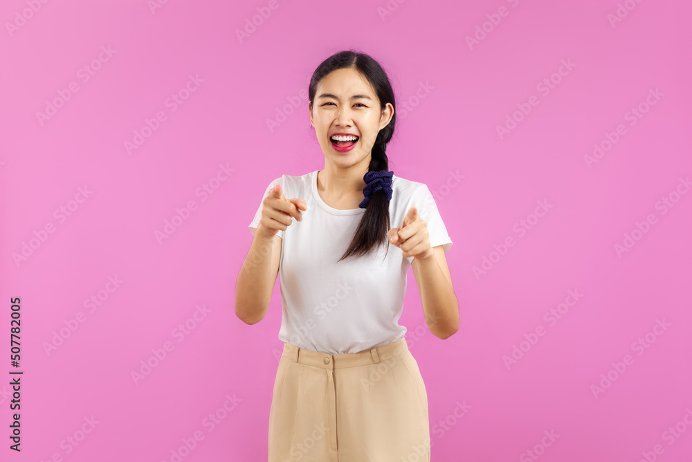 Photo of Young asian woman wearing white t-shirt posing isolated on pink wall background. Photo of Young asian woman wearing white t-shirt posing isolated on pink wall background.