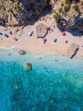 Golfo di Orosei Sardina, View from above, stunning aerial view of a beach full of beach umbrellas and people sunbathing and swimming on turquoise water. Cala Gonone, Sardinia, Italy, Cala Mariolu.