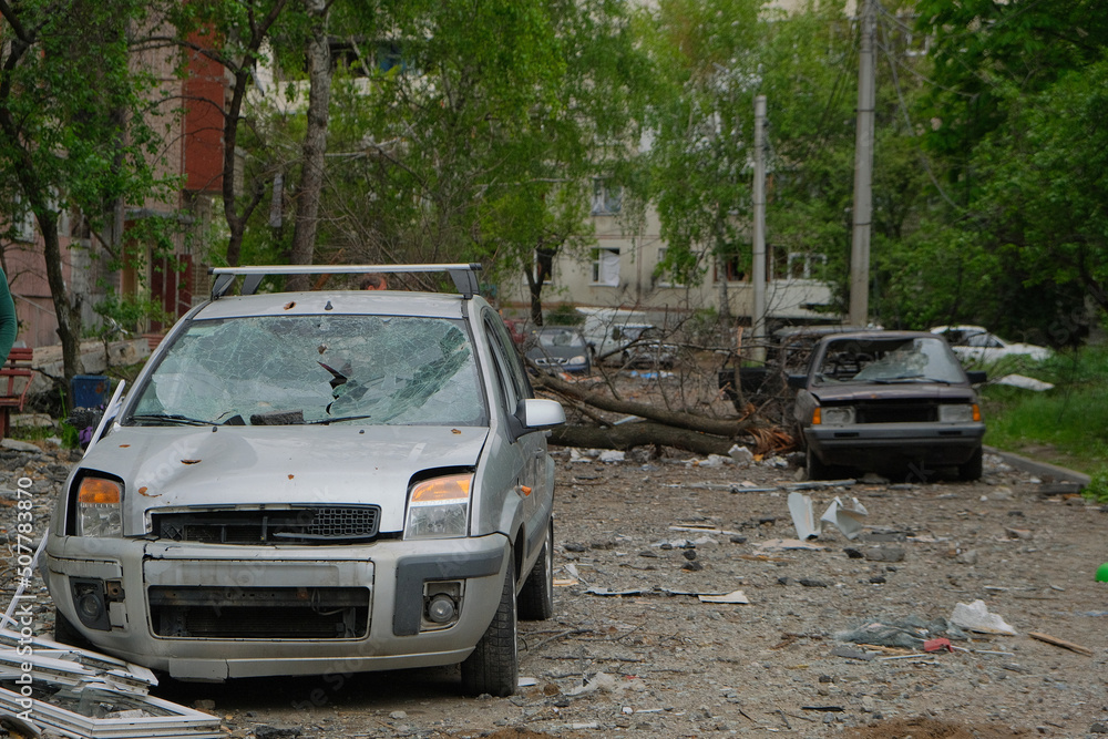 Broken cars on the street in Kharkiv after bomb attack by Russian