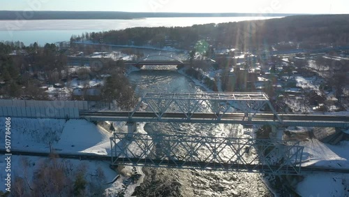 The Vuoksa River and the Losevsky Rapids. Red road bridge. Railway tracks across the river, spring landscape, Losevo photo